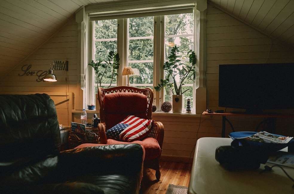 flat screen TV displaying black screen near sofa chair and sofa