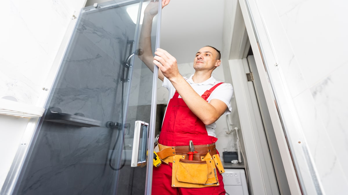 Worker measuring plastic window indoors. Installation process