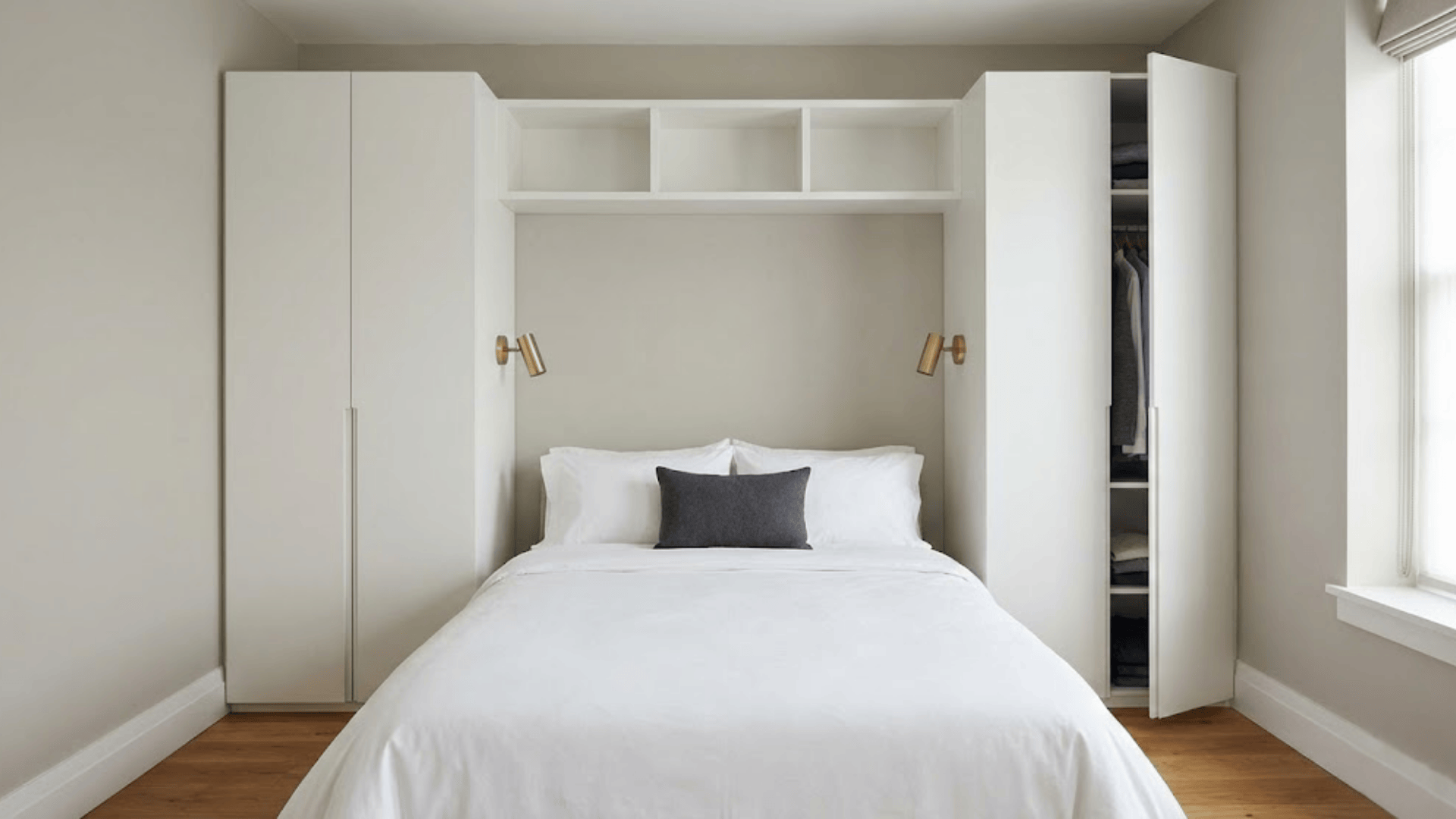 bed flanked by wardrobes