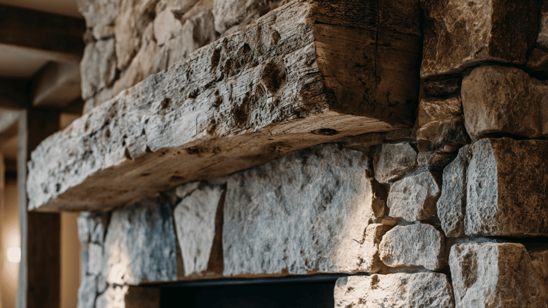 rustic fieldstone fireplace with a thick wood beam mantel