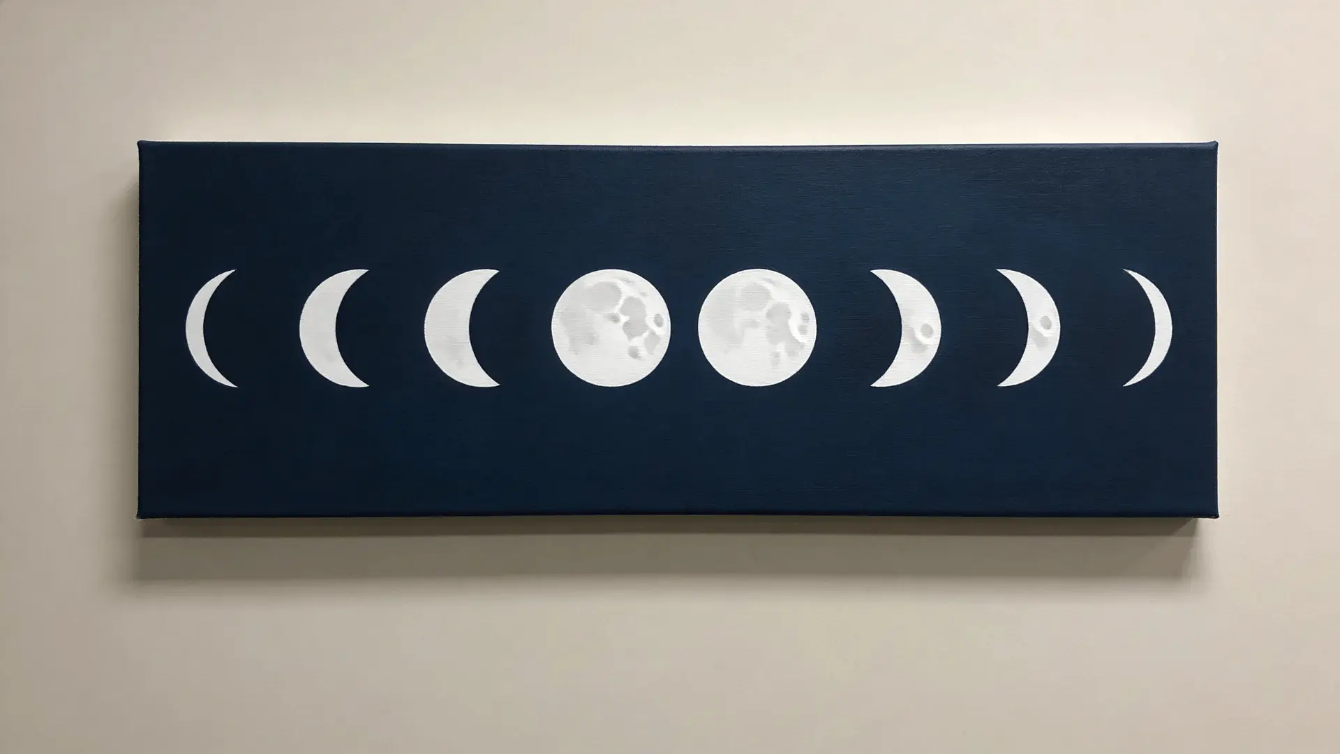 Canvas showing white moon phase shapes in a row on a dark blue background