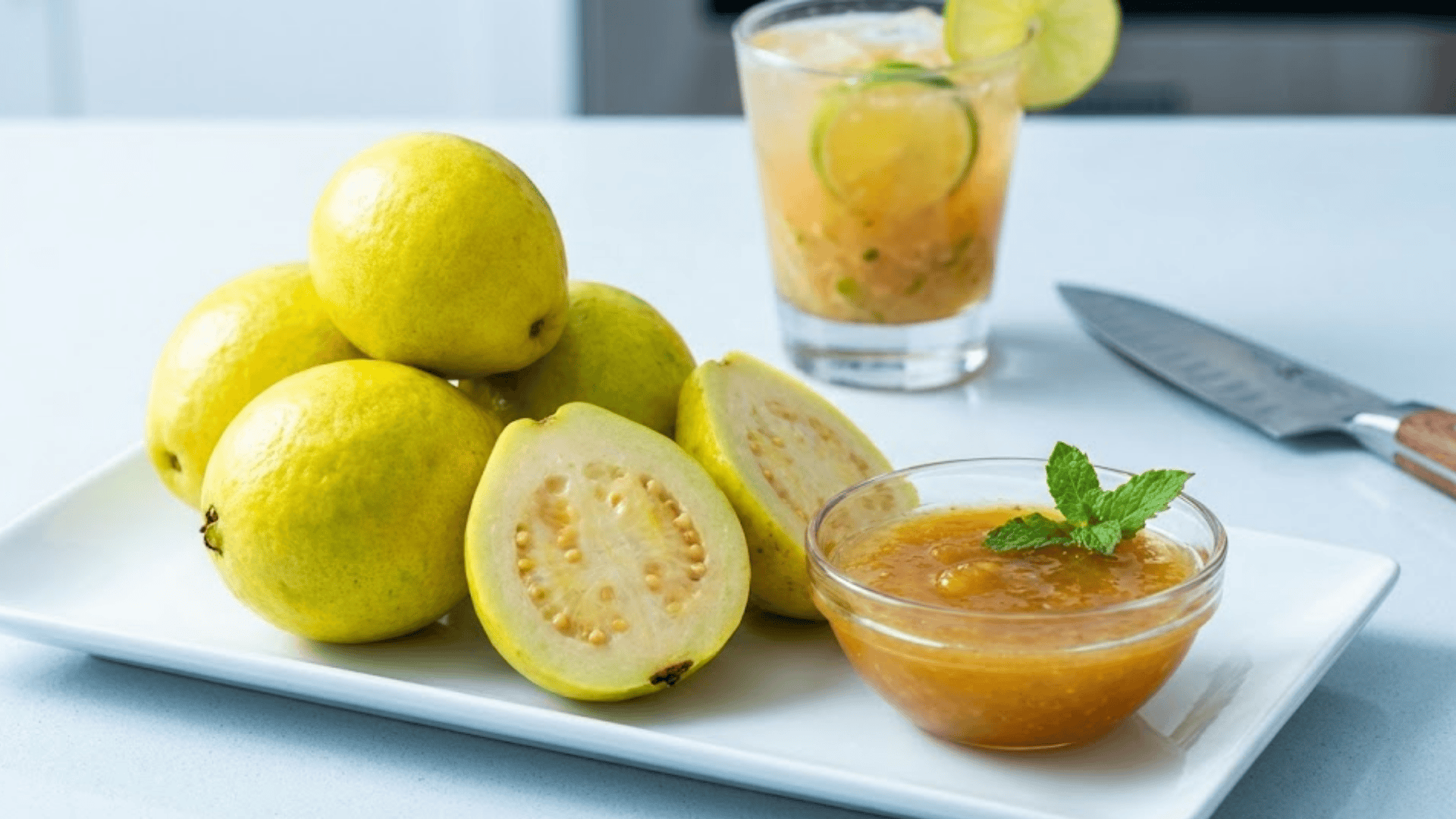 lemon guava cut open showing yellow-tinged flesh with chutney and cocktail