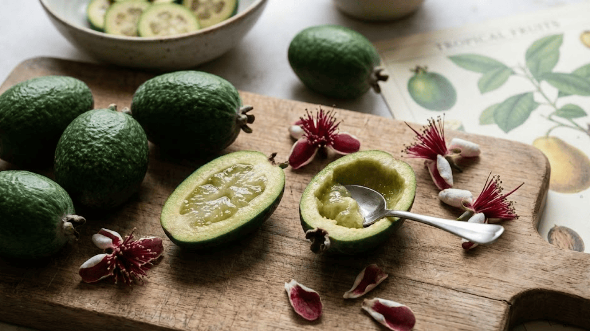 pineapple guava feijoa cut open showing green jelly flesh with spoon