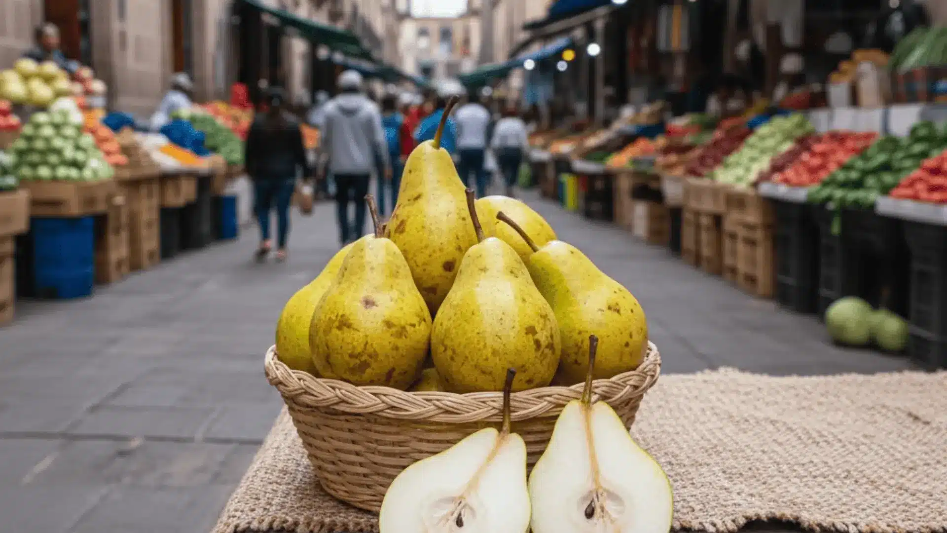 ripe mexican pears in a woven basket at a puebla market, one sliced showing white granular flesh