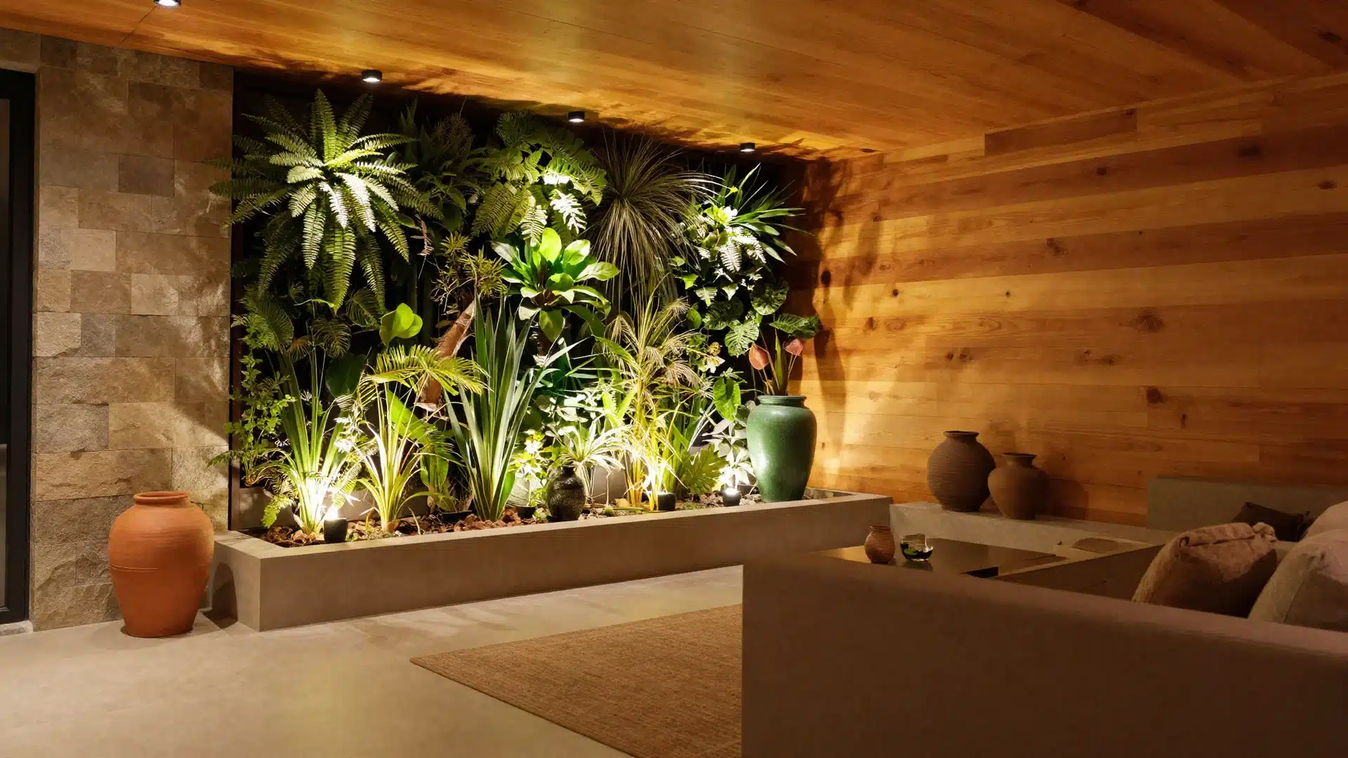 A nature-inspired basement with wood slat walls, stone tile accents, and lush indoor plants to create a grounded feel.