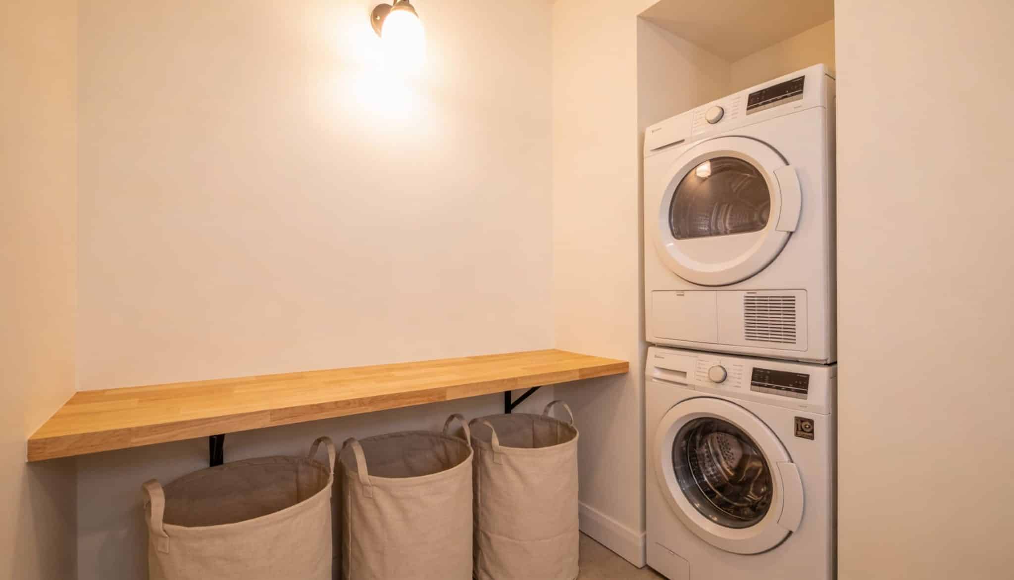 Laundry room with walls painted in a creamy, warm off-white, providing a soft and comfortable feel.