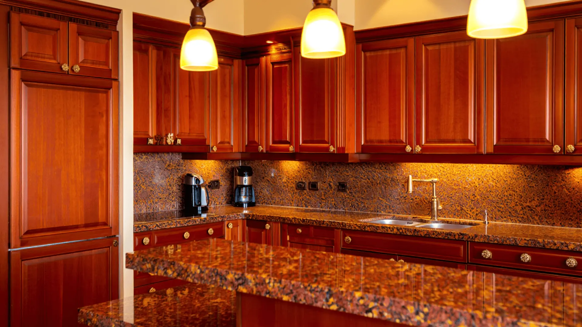deep cherry wood raised panel cabinets with brass hardware in a formal traditional kitchen