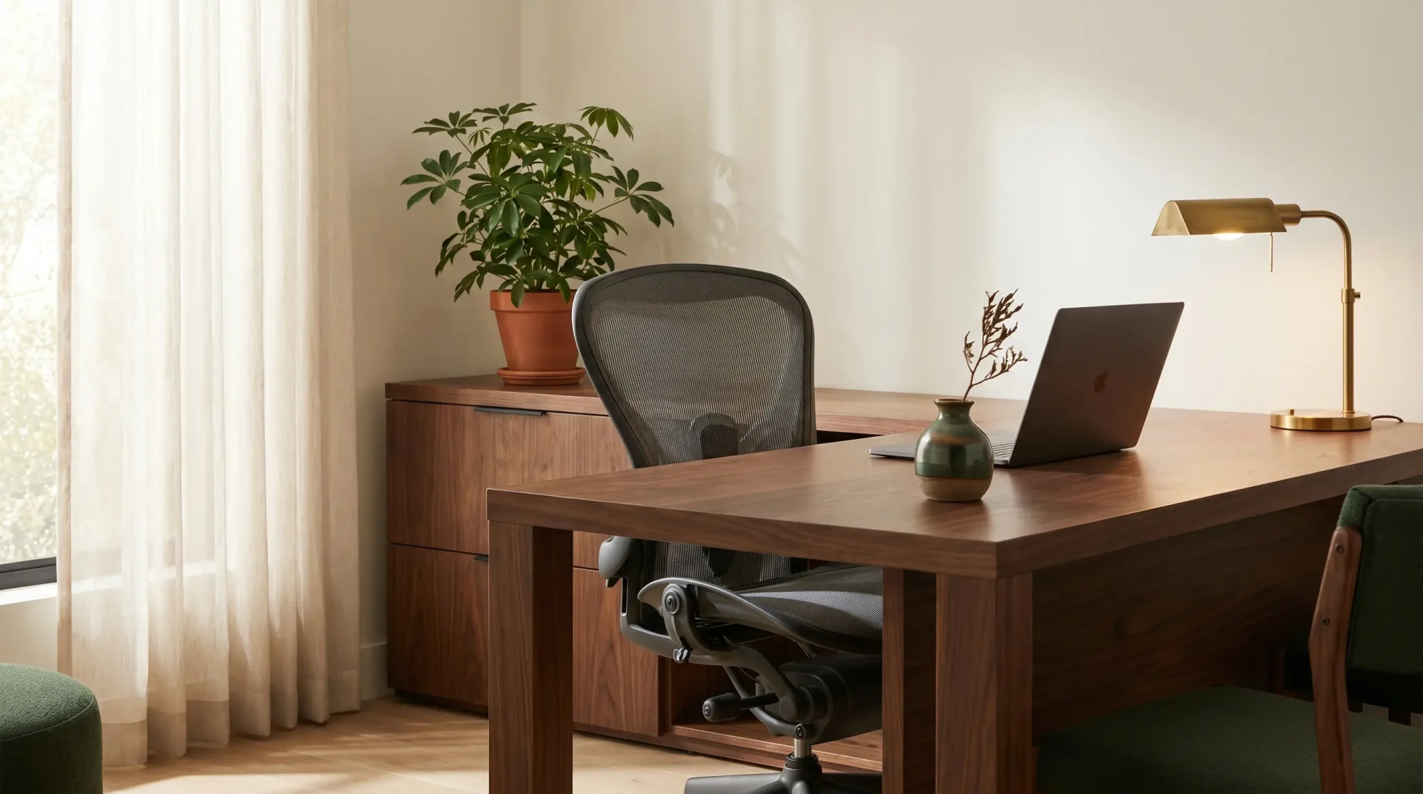 Modern home office with wooden desk, ergonomic chair, and laptop under warm lighting