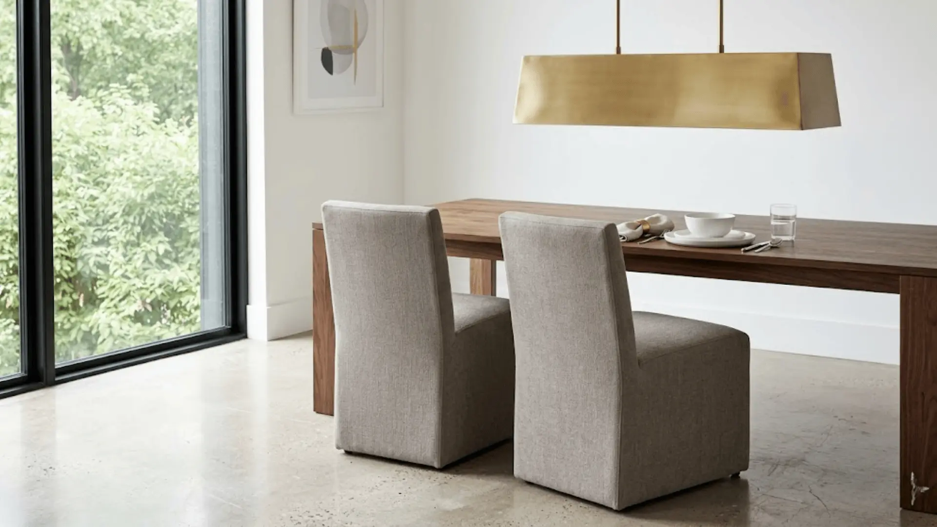 warm grey fully upholstered parsons chairs at a dark walnut table in a contemporary dining room