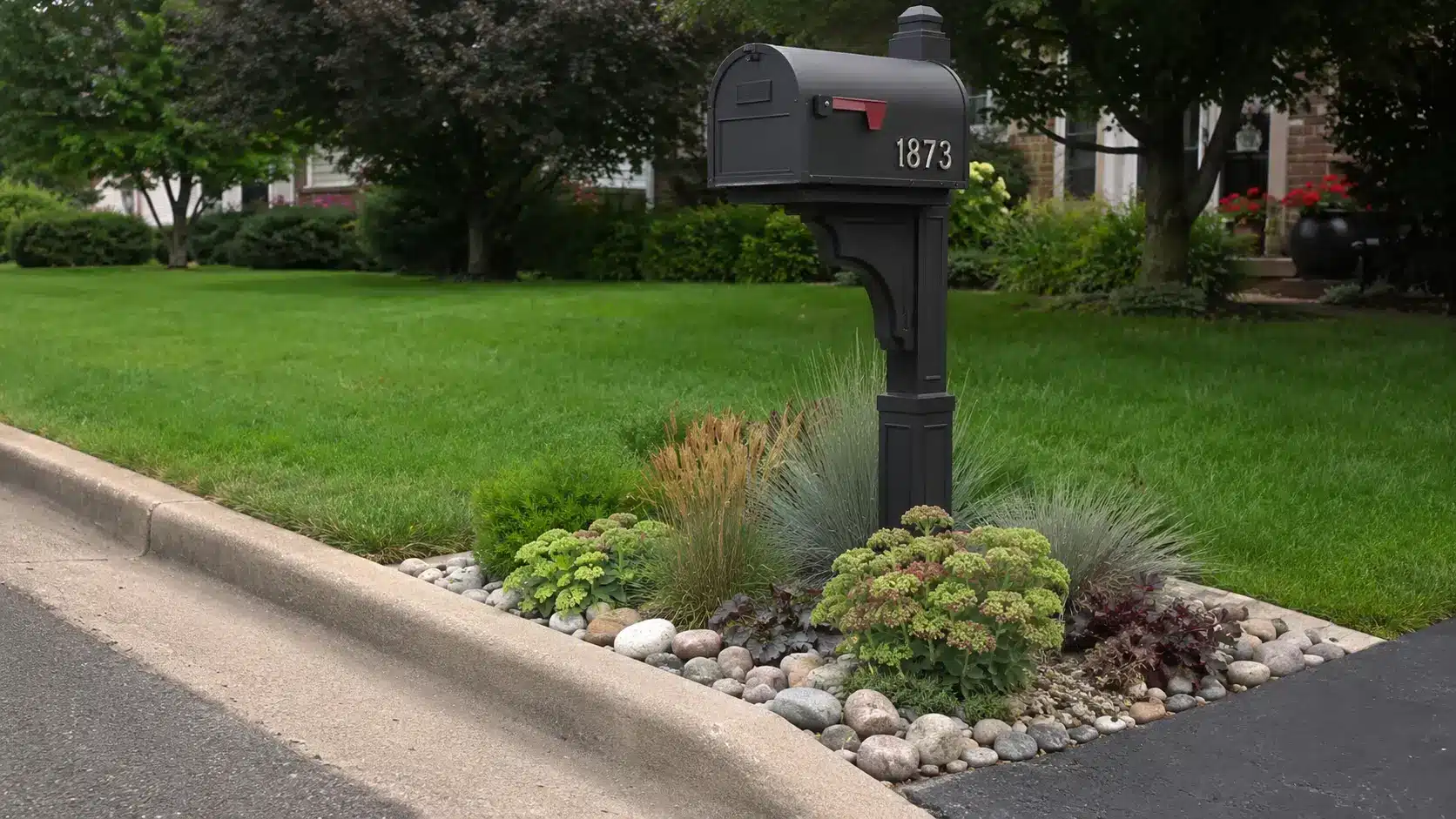 a small rock garden around the mailbox adds curbside color and structure