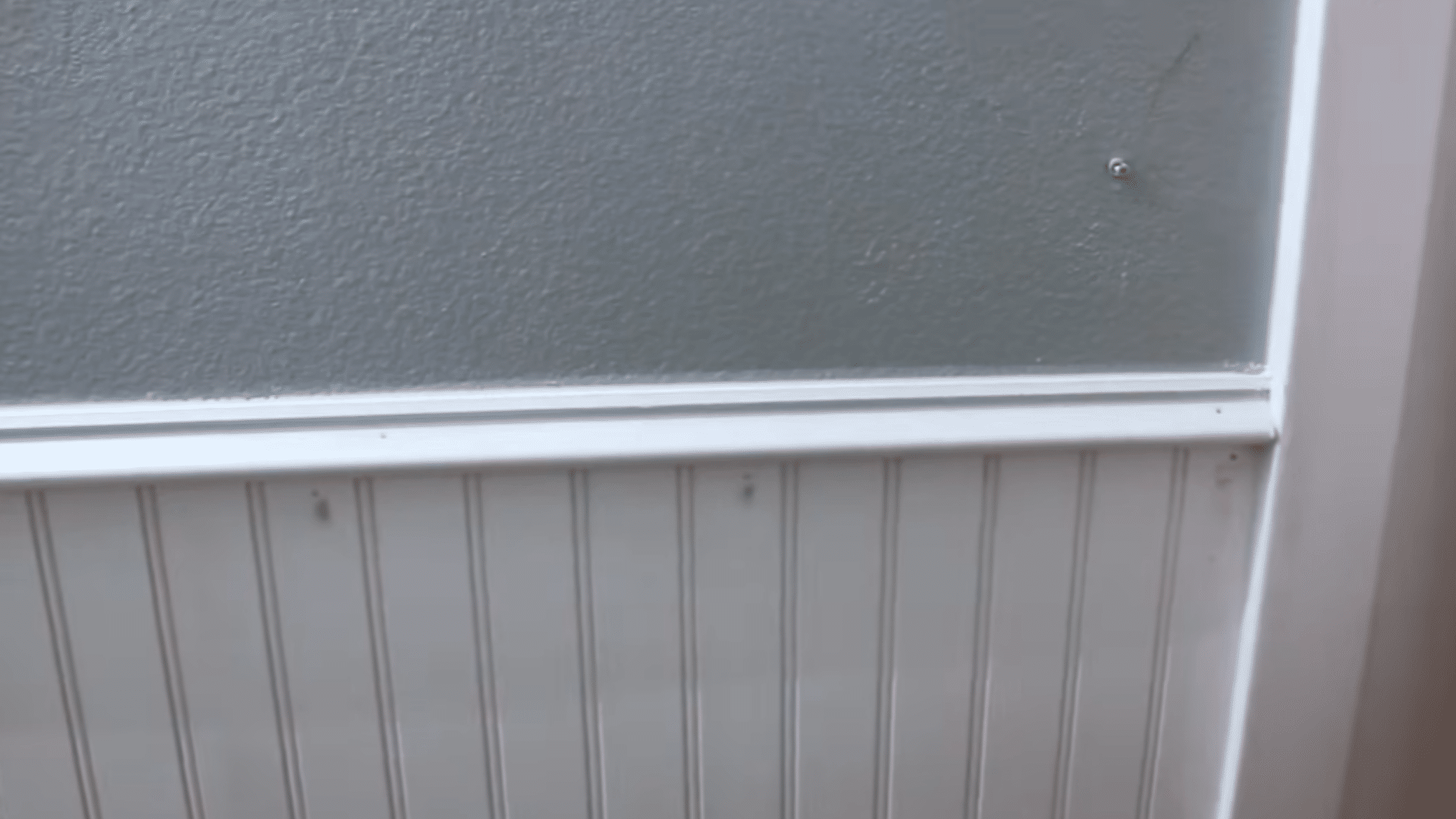 _adding top trim caulk filler and paint to finish the beadboard wall and hide raw edges and nail holes