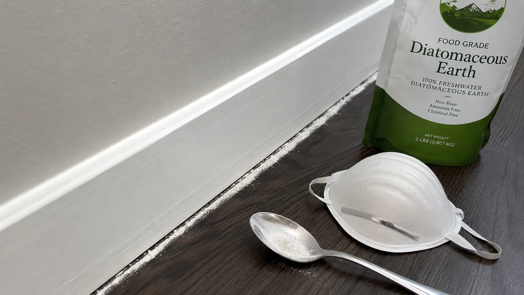 a realistic close up showing food grade diatomaceous earth placed along a dry baseboard gap where ants may enter