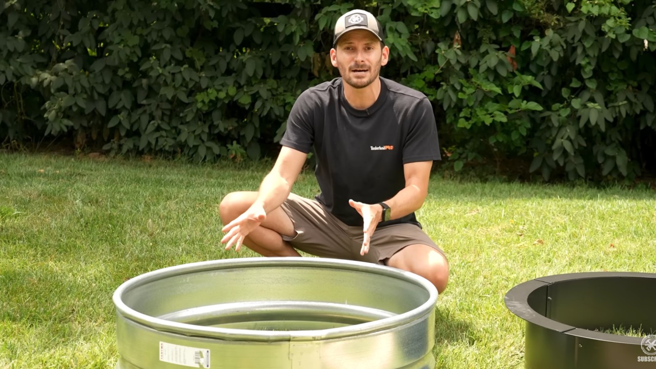 diy backyard ideas showing fire ring inserts on grass before choosing materials for a stone fire pit