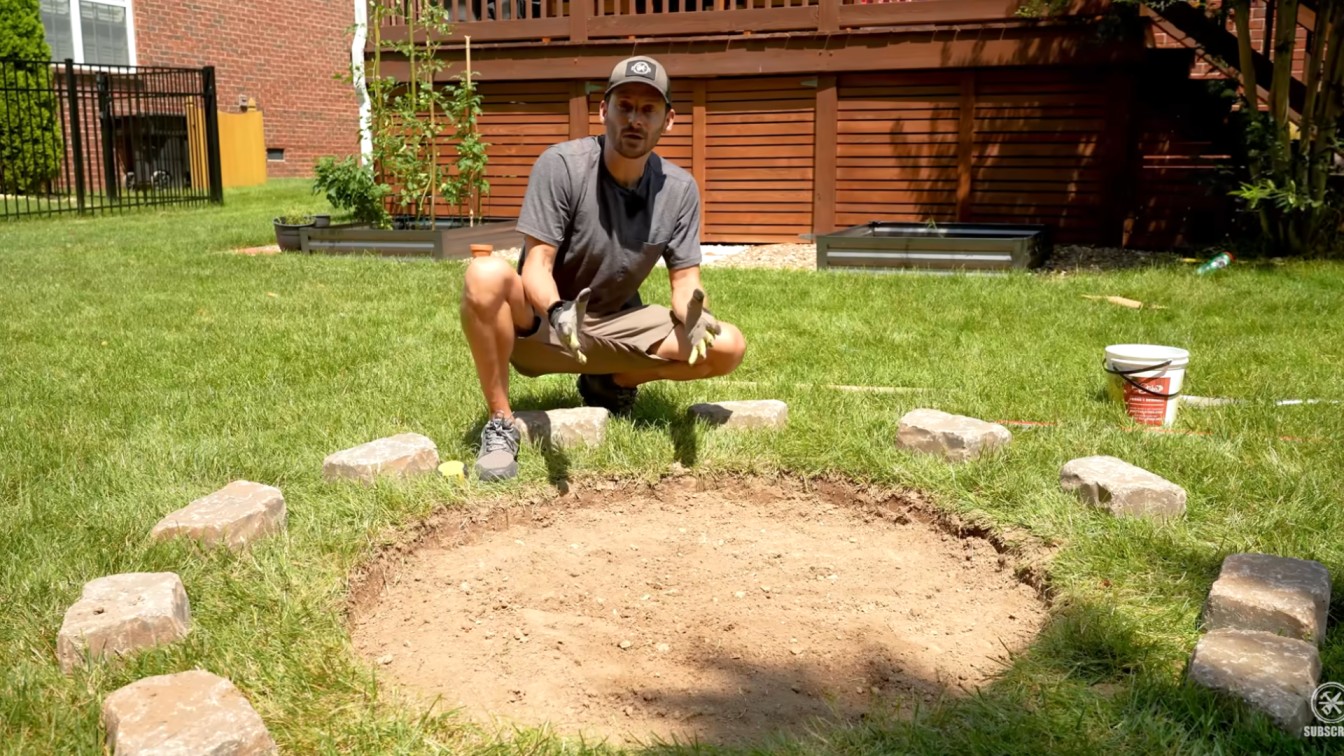 diy backyard ideas showing a marked fire pit area dug into grass for a simple weekend backyard build