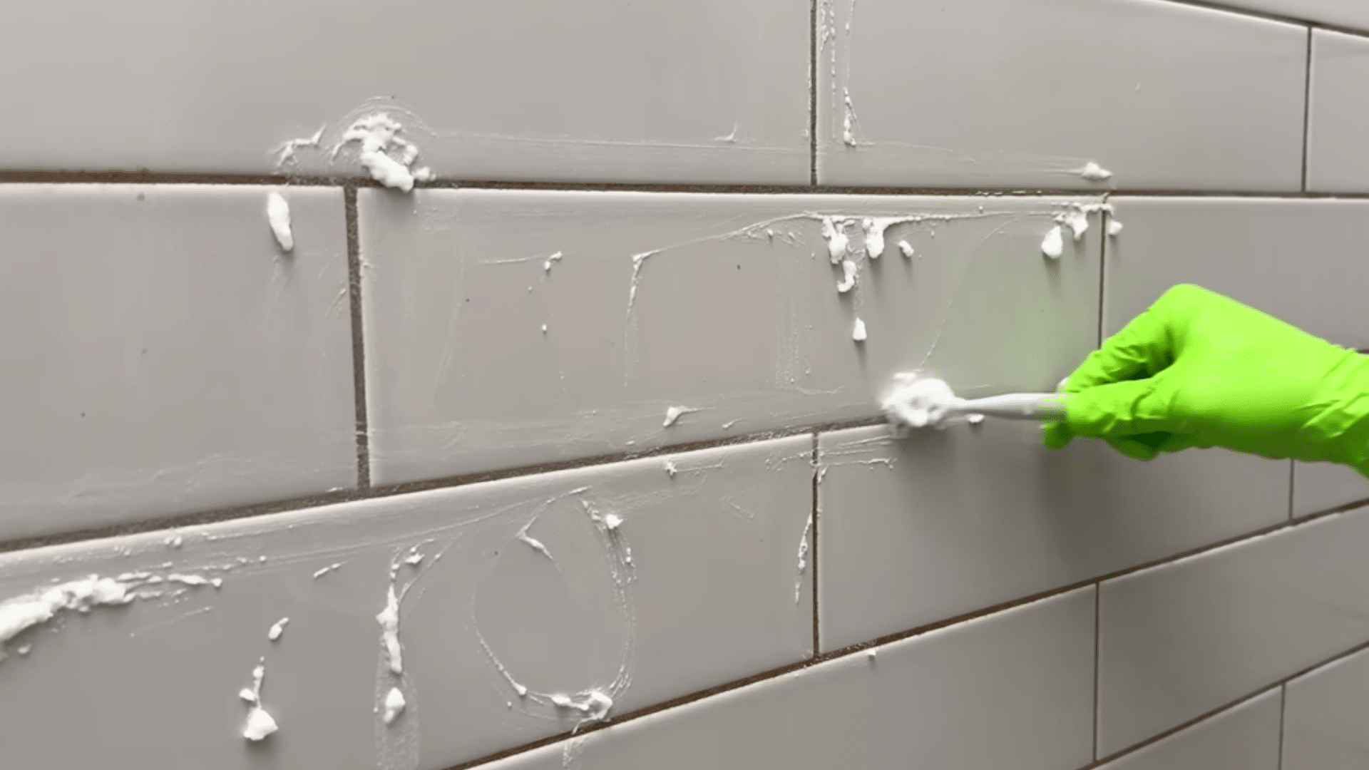 apply baking soda and hydrogen peroxide paste to grout for medium buildup removal