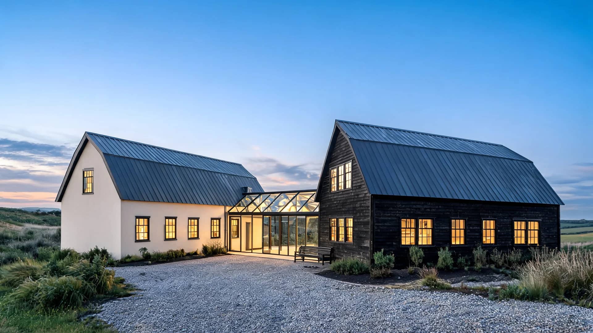 modern farmhouse exterior with twin barn volumes linked by glass and warm wood against open land