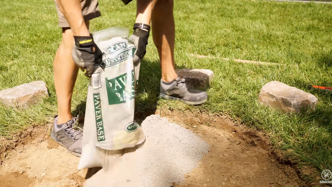 diy backyard ideas showing paver base being poured into a fire pit area for a level stone foundation