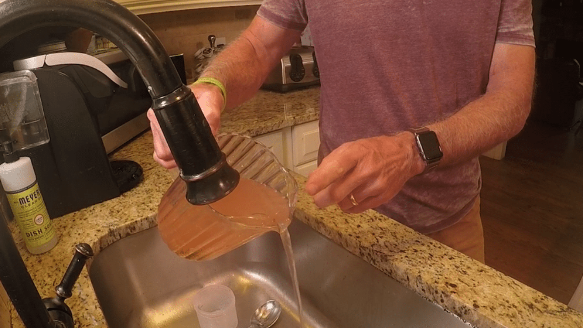 clean tomato seeds being rinsed in water separating healthy seeds from pulp and debris