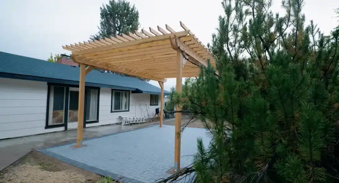 securing the final anchor points and inspecting every joint to confirm the pergola is sturdy