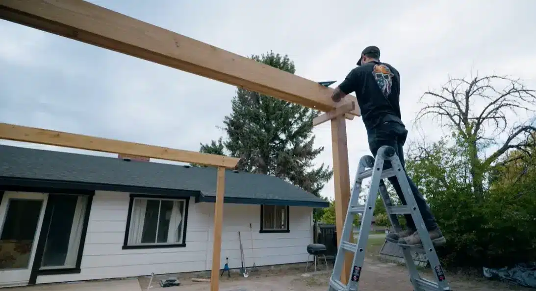 installing angled wooden corner braces between the posts and beams to add extra strength and stability