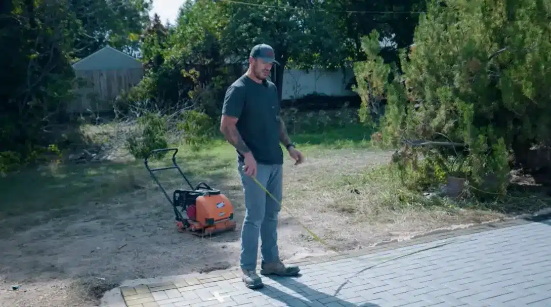 marking out the pergola footprint on the ground using stakes and string before digging begins