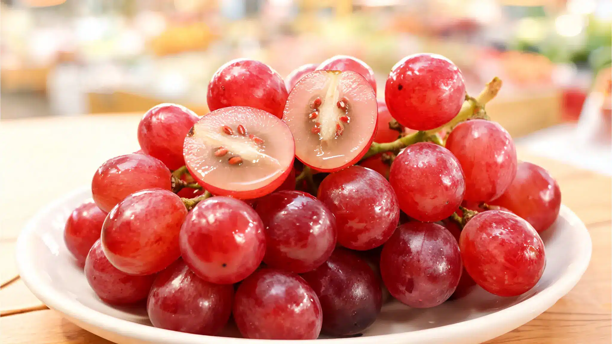 red globe grapes on a fruit platter with visible seeds