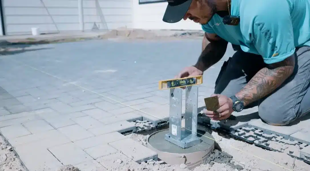 setting wooden posts upright in the holes then bracing and anchoring them so they stay level